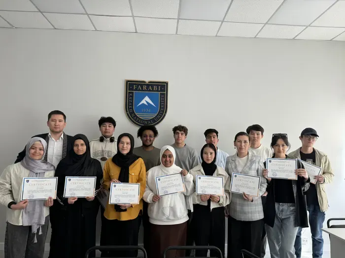 AI course participants holding their completion certificates at KazNU.